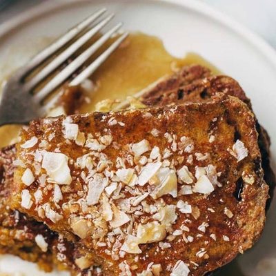 Pumpkin Bread French Toast on a plate with syrup.