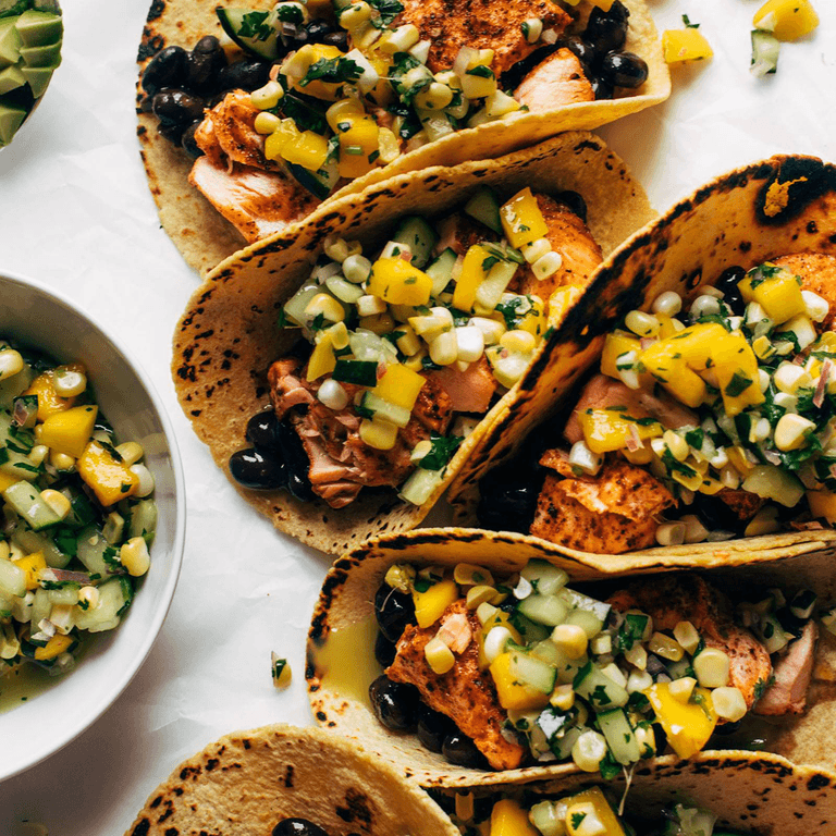 Salmon tacos topped with mango corn salsa.